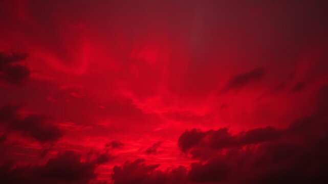 Dramatic red sky with clouds at sunset or sunrise creating a vibrant atmosphere