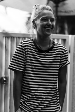 Happy woman enjoying party with friends in summer house