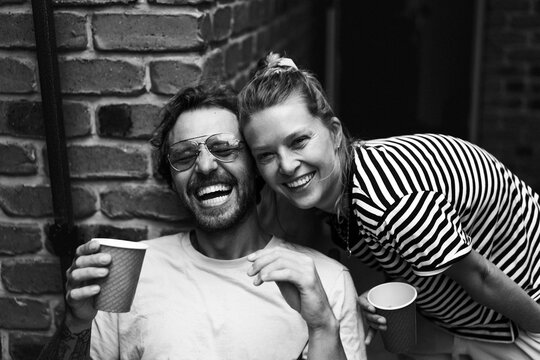 Portrait of happy male and female friends posing in back yard at party