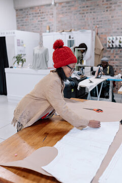 Seamstress creating a pattern to sew