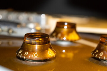 Gold electric guitar  macro tone knobs.