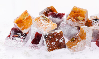 Sweet food Turkish delight, assorted rahat locum in form of cubes with nuts and powdered sugar, traditional food, on white background