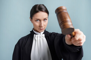 Judge with mallet on light blue background