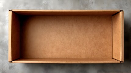 A large empty brown cardboard box sits open on a textured gray surface ready for packaging or shipping.