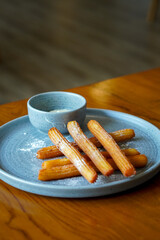 Churros with white chocolate, captured on May 13, 2025. Crispy golden churros paired with smooth, melted white chocolate for a sweet and indulgent treat