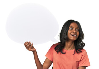 Indian woman with dialogue bubble looks aside smiling, cheerful and pleasant.