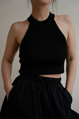 Black Crop Top and High-Waisted Pants Front Pose. Chic Summer Outfit with Black Halter Crop Top and...
