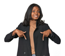 Young Indian woman in business suit points down with fingers, positive feeling.