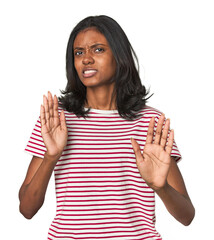Portrait of a young Indian woman rejecting someone showing a gesture of disgust.
