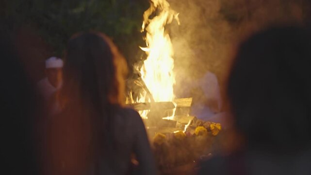 Sacred Fire Ritual with Silhouettes and Bonfire at Night