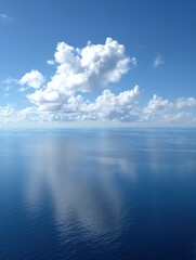 Fototapeta premium Aerial view of ocean and sky with clouds on a sunny day; calm blue sea reflecting sunlight; peaceful seascape from above