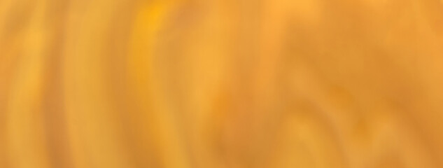 Blurred orange and golden background. Defocused art abstract gradient backdrop