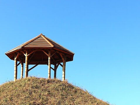 Serene Bamboo Gazebo on a Grassy Hilltop under a Clear Blue Sky A Peaceful and Tranquil Summer Scene - Powered by Adobe