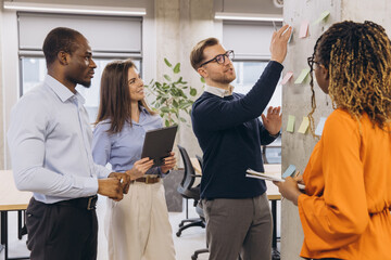 Business Team Brainstorming with Sticky Notes in Modern Office