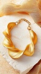 Gold choker necklace showcasing sculptural design on polished marble surface
