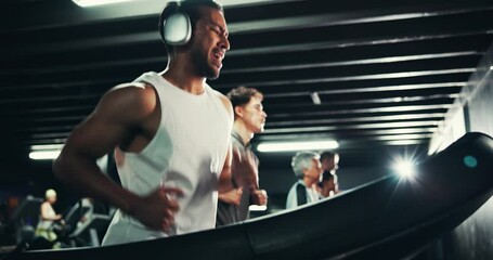 Headphones, sweating and man on treadmill in gym for running, exercise and endurance with fatigue and podcast. Cardio, tired runner and machine for training, intense and radio at fitness center