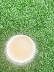 Fresh Cup of Coffee on Green Grass &mdash; Top View Minimalist Composition