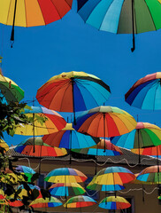 Colorful umbrellas on blue sky background