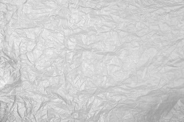 Plastikfolieweiss grau als zerknitterter Hintergrund