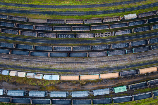 Aerial view of freight train yard with multiple parallel tracks and cargo trains