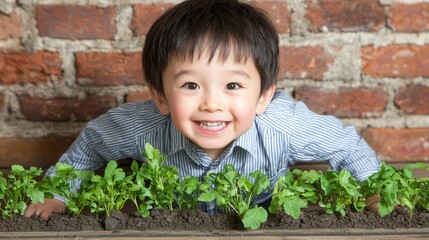 nature conservation, world environment day concept. Cheerful child gardening with plants in front of a brick wall.