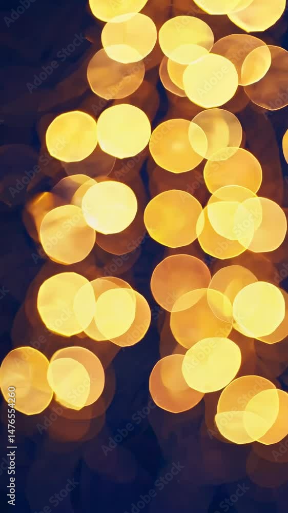 Poster dynamic transition of warm bokeh lights in vertical motion on dark background