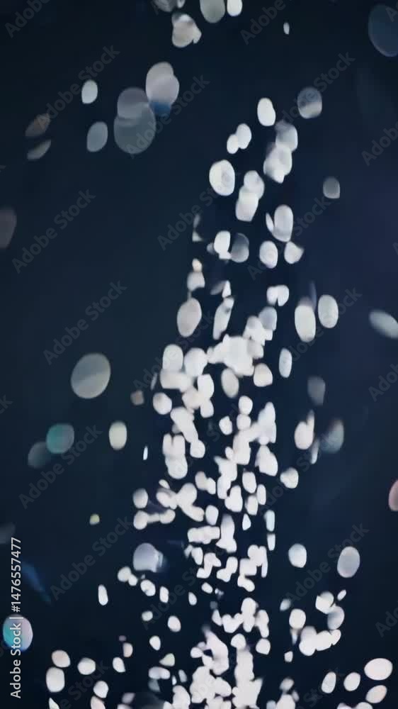 Poster dynamic abstract particle burst against dark background showcasing fluid motion and light interplay