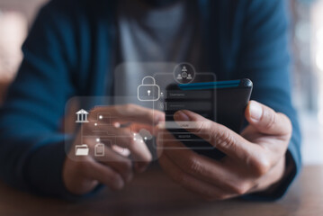 Close-up of hands using a smartphone with holographic security icons, representing mobile banking, data protection, and secure login.