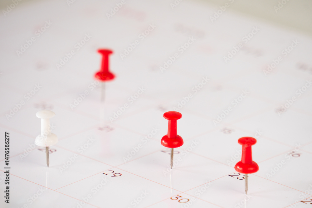 Poster calendar and marked date with push pin