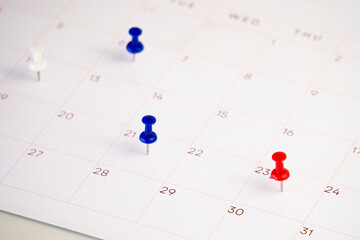 date with push pin on a calendar