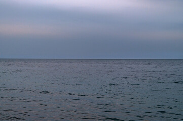 Ocean with sky in horizon. Calm sea in evening. Seascape at sunset.