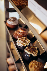 Appetizing cinnamon buns with cream in the bakery window.