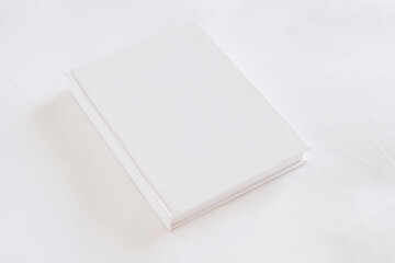 White book mockup on white bed