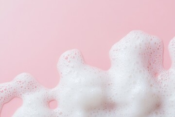 Fototapeta premium Beauty Product Foam Soap. Abstract background white soapy foam flowing texture. Shampoo foam with bubbles. Bubble surface isolated on pastel pink coral rose color. Suds. Facial cleanser. Froth Pattern