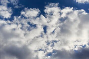 White cumulus clouds against the sky create a sense of infinite space and height. Used in themes of self-development, air travel, and ecology.
