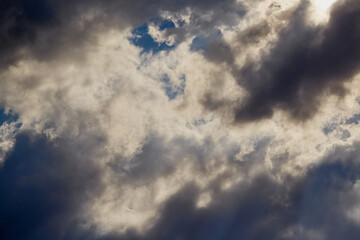 Bright sun breaking through dense clouds is a metaphor for enlightenment and overcoming difficult situations. This shot is suitable for spiritual and motivational projects.