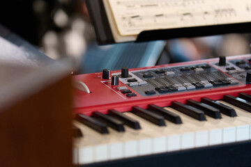 Music: Close-up of a modern red stage piano 