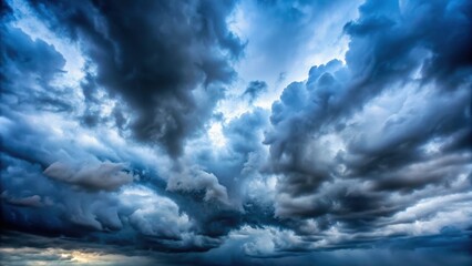 Obraz premium Atmospheric misty blue sky with thick grey clouds obscuring the view, evoking a sense of mystery and foreboding