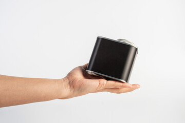 Black can for packaging in hand on white background.