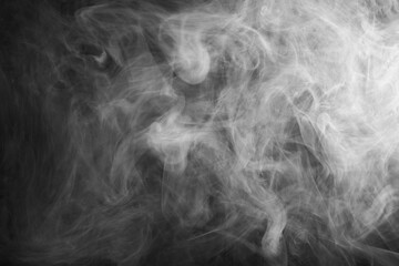 Abstract smoke texture over black background. Fog in the darkness.