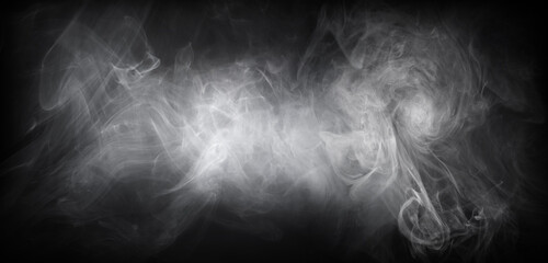 Abstract smoke texture over black background. Fog in the darkness.