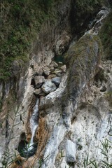 Serene Waterfall Cascading Through Rugged Mountain Gorge Stunning Natural Beauty