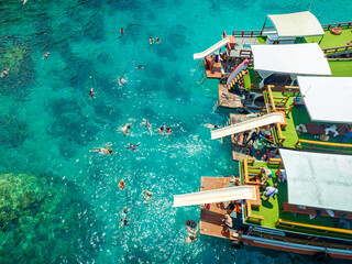 Top aerial view of  natural bay serving ton of traveler tourist  take bundle of tour boats dropped anchorage let people enjoy water sport together  in summertime Thailand travel and visiting