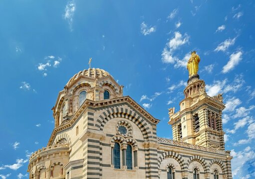 Close-up of the Notre Dame de la Garde with a golden statue of the Virgin Mary and Jesus Christ on the bell tower, Marseille, Provence-Alpes-Cote d'Azur, France