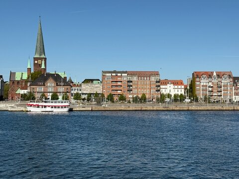 Fototapeta View into land of city waterfront with Aarhus Cathedral (Aarhus Domkirke), Aarhus, Jutland, Denmark