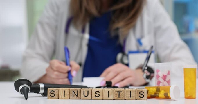 Woman writes prescription for Sinusitis treatment near medication and otoscope on table. Importance of proper diagnosis and care in healthcare
