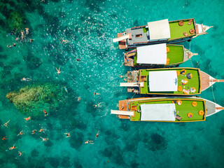 Top aerial view of  natural bay serving ton of traveler tourist  take bundle of tour boats dropped anchorage let people enjoy water sport together  in summertime Thailand travel and visiting