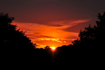 Beautiful sunset sky over the silhouette of a forest valley