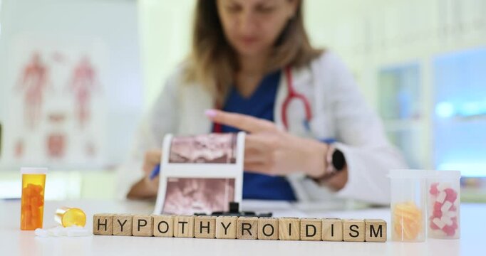 Female doctor holds ultrasound scan of thyroid gland and studies medical history of patient with Hypothyroidism. Medication treatment with pills