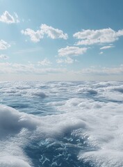 Obraz premium A vast expanse of puffy white clouds, floating over a tranquil, light-blue sea. A bright, clear sky above